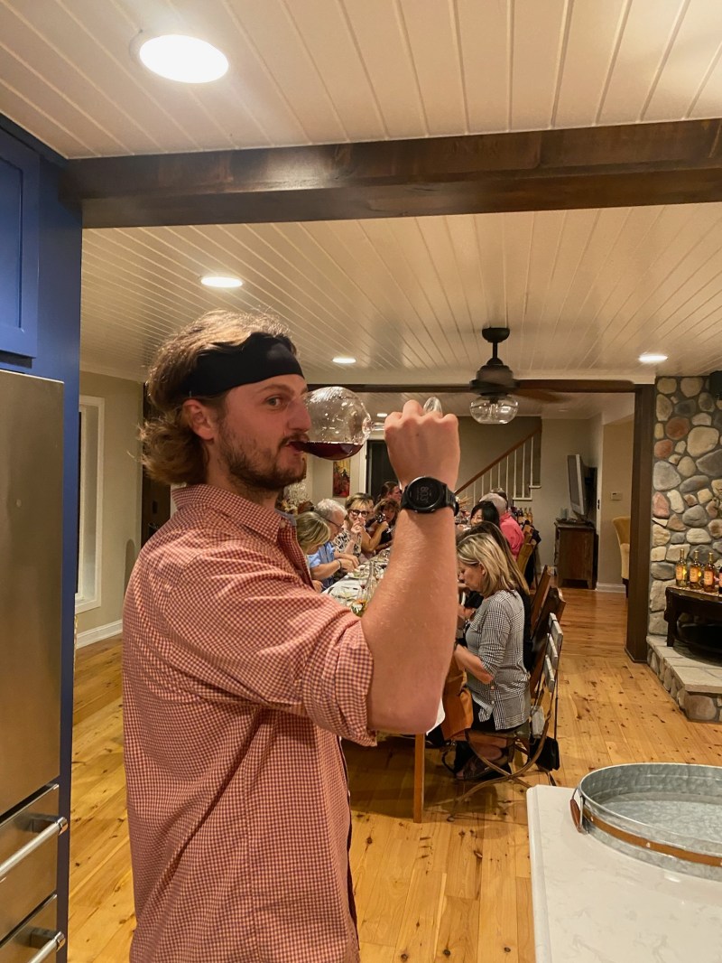 a man holding a phone and standing in a room